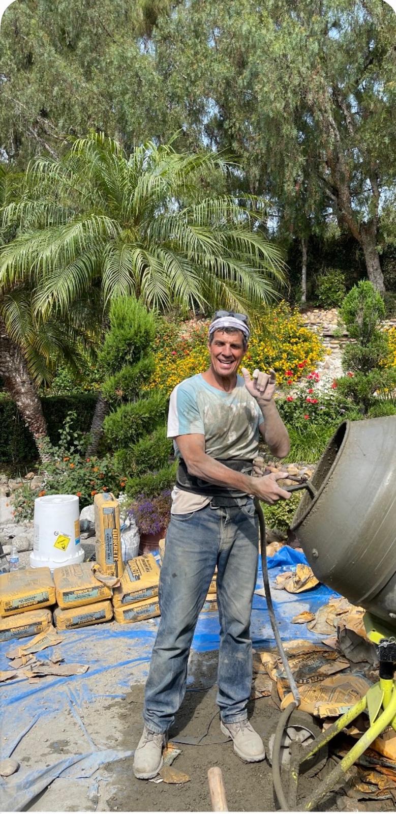 Roby working beside a concrete mixer on site