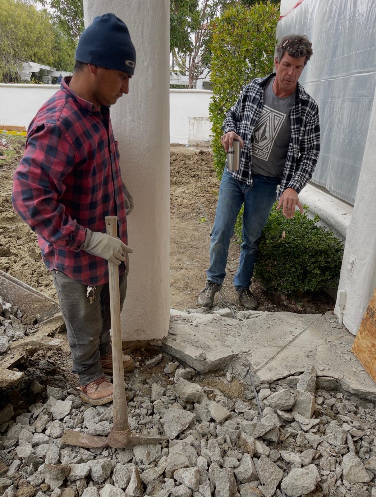 Roby and a crew member working on an outdoor renovation